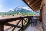 This stunning balcony boasts breathtaking mountain views and a private seating area, perfect for relaxing and enjoying the scenery.