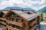 This stunning chalet boasts multiple levels of luxurious accommodations, each with its own private balcony offering breathtaking mountain views.