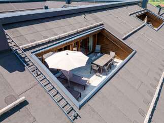 This stunning property boasts a unique rooftop terrace, accessible via a convenient ladder, perfect for outdoor entertaining.