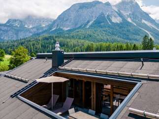 This stunning property boasts a unique rooftop terrace offering breathtaking mountain views.