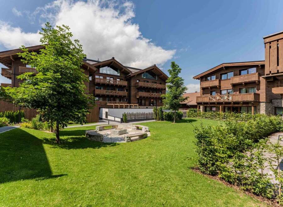 Nestled in a serene landscape, this stunning property boasts multiple buildings with charming wooden exteriors and spacious balconies.