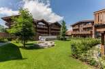 Nestled in a serene landscape, this stunning property boasts multiple buildings with charming wooden exteriors and spacious balconies.