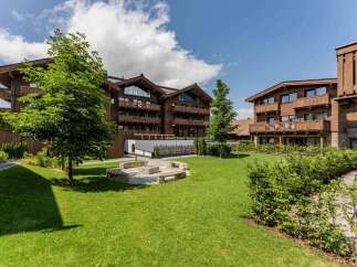 Nestled in a serene landscape, this stunning property boasts multiple buildings with charming wooden exteriors and spacious balconies.
