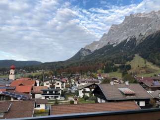 Nestled in a charming village, this property offers breathtaking views of majestic mountains and lush greenery.