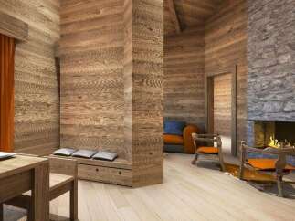 This stunning chalet boasts a cozy living area with a wood-burning fireplace, creating a warm and inviting atmosphere.