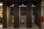 Modern restroom design with sleek dark gray partitions, wood-paneled doors, and stylish geometric artwork.