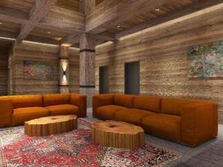 This stunning property boasts a spacious living area with plush orange sofas, perfect for relaxation.
