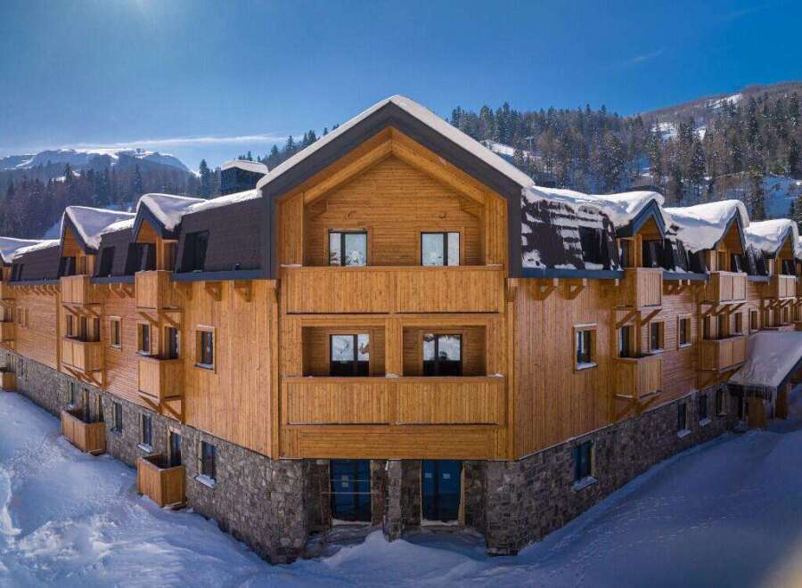 Nestled in a snow-covered mountainside, this stunning wooden chalet offers breathtaking views and luxurious accommodations.