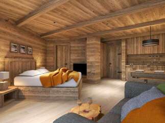 This stunning chalet boasts a cozy and luxurious interior, featuring a spacious bedroom with a comfortable bed and a rustic wooden headboard.