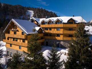 Nestled in a snowy mountainside, this stunning wooden chalet offers breathtaking views and luxurious accommodations.