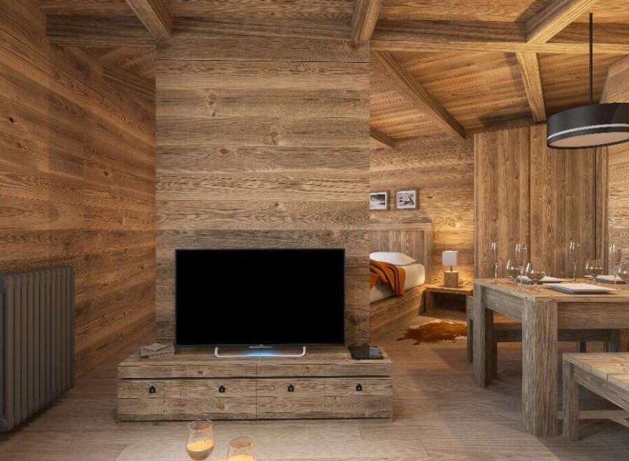 This stunning chalet boasts a spacious open-plan living area with a cozy wooden interior, perfect for relaxing after a day on the slopes.