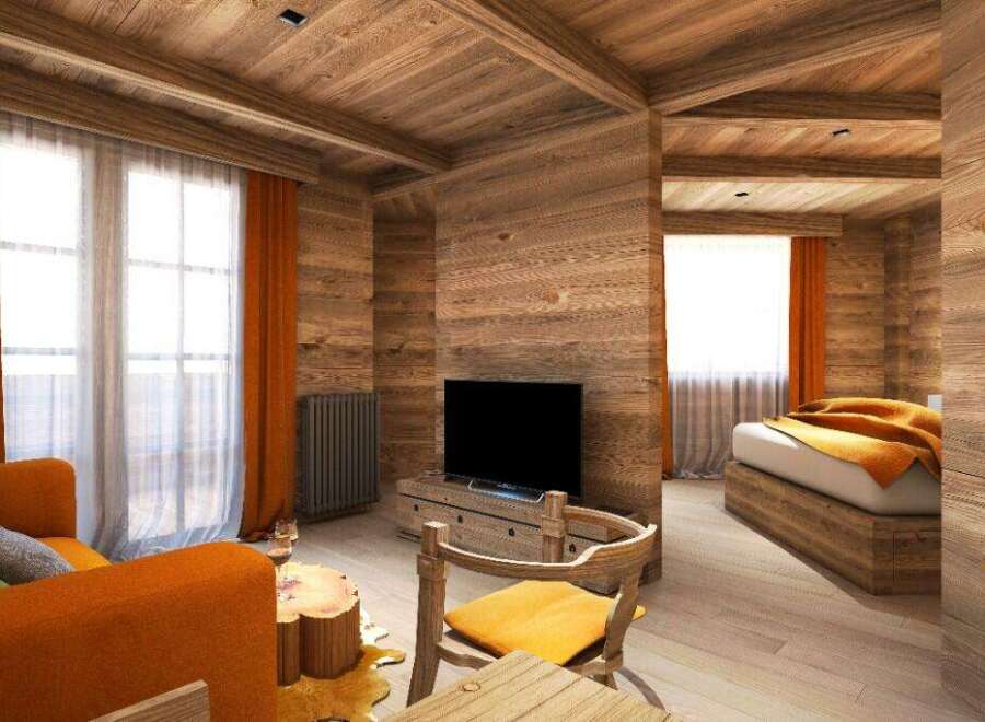 This stunning wooden chalet boasts a cozy living area with an orange couch and a rustic wooden coffee table, perfect for relaxing after a day of adventure.