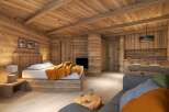 This stunning chalet boasts a cozy and luxurious interior, featuring a spacious bedroom with a comfortable bed and a rustic wooden headboard.