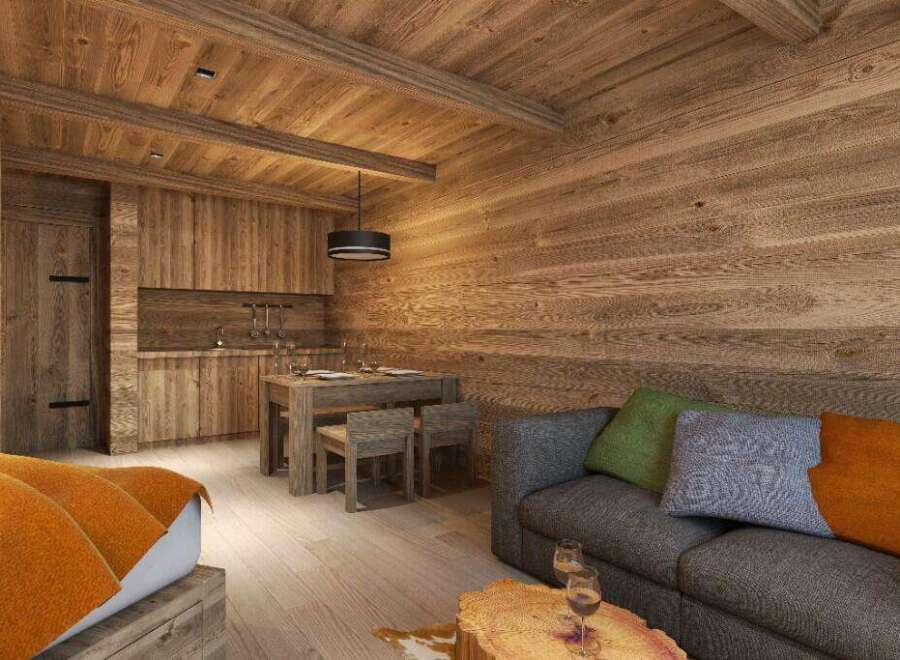 Cozy wooden cabin apartment with a fully equipped kitchen, dining area, and comfortable living room.