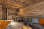 Cozy wooden cabin apartment with a fully equipped kitchen, dining area, and comfortable living room.
