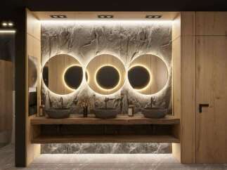 This stunning bathroom boasts a luxurious design with three circular mirrors illuminated by warm lighting, creating a spa-like atmosphere.