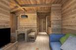 This stunning chalet boasts a spacious open-plan living area with a rustic wooden dining table and comfortable blue sofa.