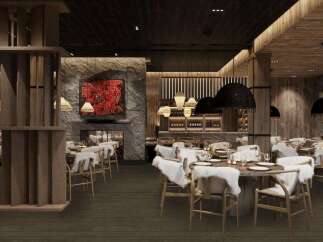 This stunning restaurant boasts a rustic-chic design with exposed wood beams, a stone fireplace, and plush fur accents.