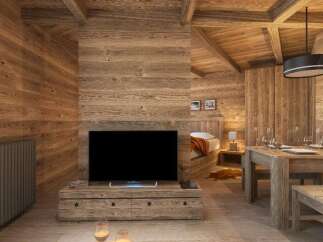 This stunning chalet boasts a spacious open-plan living area with a cozy wooden interior, perfect for relaxing after a day on the slopes.