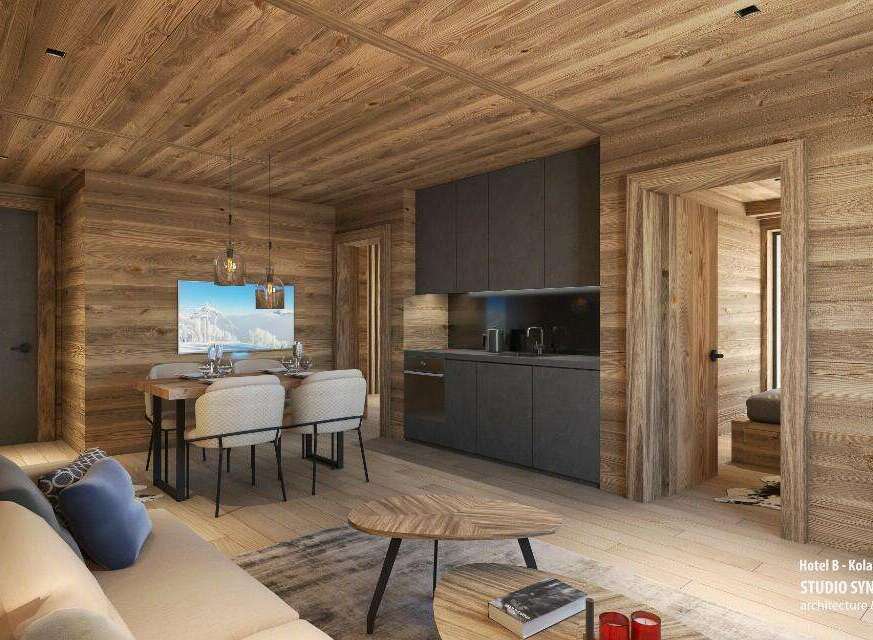 This stunning hotel room boasts a cozy and modern design, featuring a spacious living area with a comfortable sofa and a dining table for four.