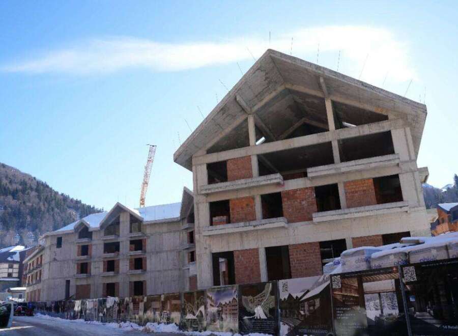 This unfinished hotel is situated in a mountainous region, offering stunning views.