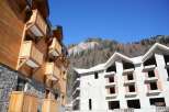 Discover this stunning property nestled in the mountains, featuring two buildings with unique architectural styles.
