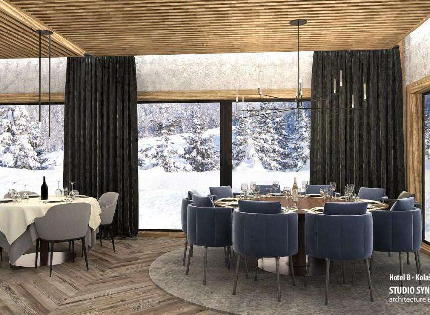 This stunning restaurant boasts floor-to-ceiling windows showcasing breathtaking snowy mountain views, creating a serene and elegant ambiance.