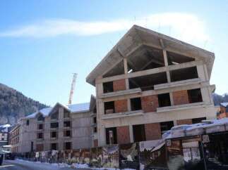 This unfinished hotel is situated in a mountainous region, offering stunning views.