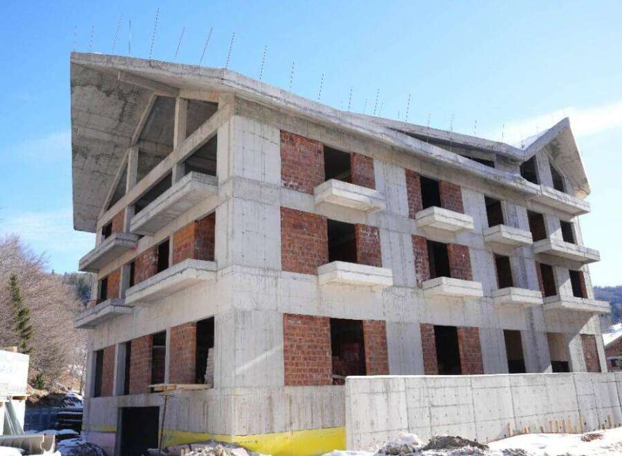 This stunning multi-level building boasts a modern architectural design with a unique sloped roofline.