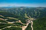 Nestled in a lush mountain range, this stunning property boasts breathtaking views and ski slopes.