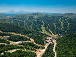 Nestled in a lush mountain range, this stunning property boasts breathtaking views and ski slopes.