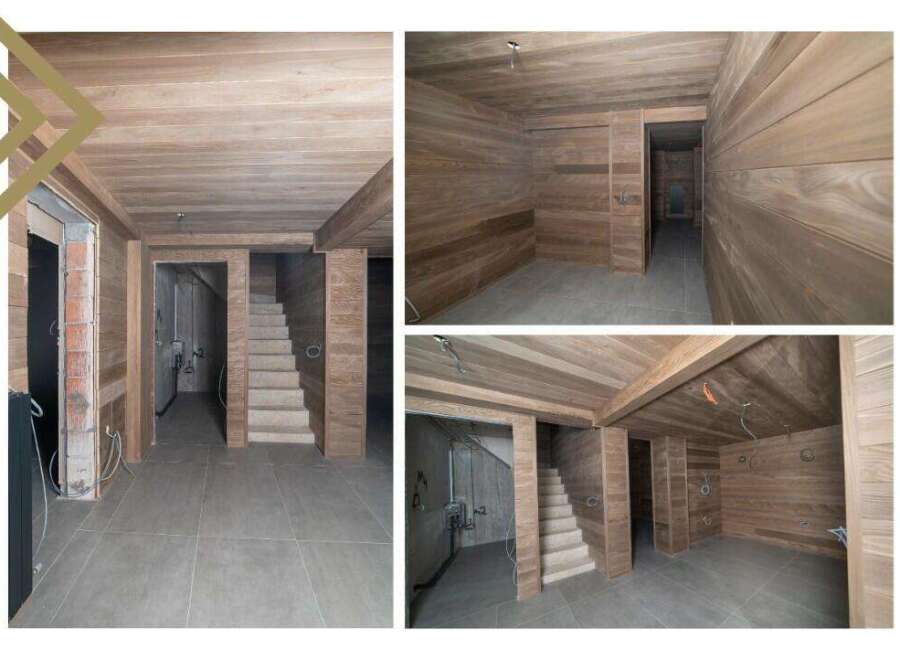 This stunning property boasts a beautifully finished basement with wood paneling on the walls and ceilings, creating a warm and inviting atmosphere.