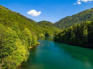 Nestled in a lush green valley, this serene lake offers breathtaking views of the surrounding mountains.