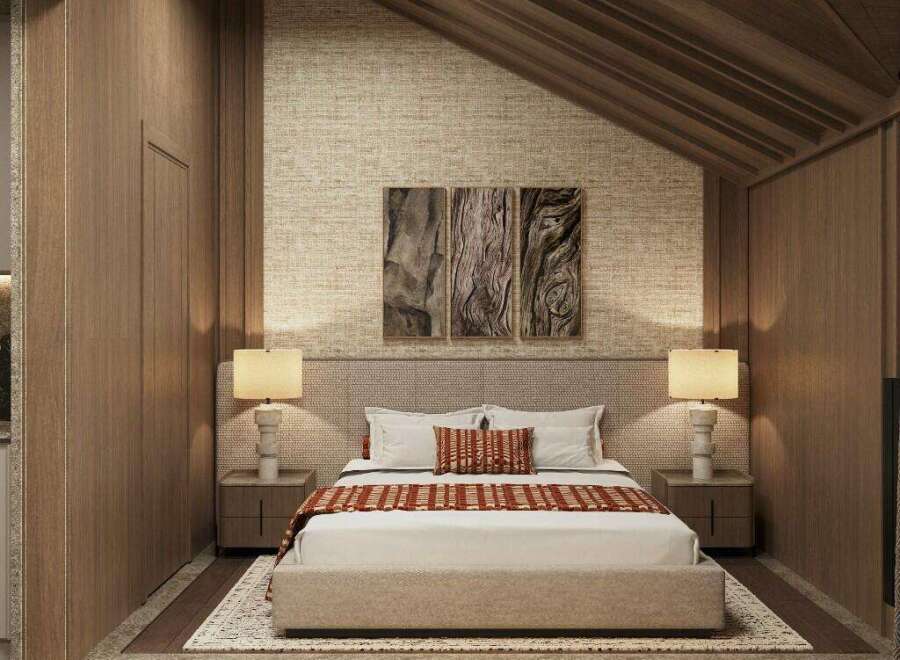 This stunning bedroom boasts a cozy and sophisticated atmosphere, featuring a plush bed with a textured headboard and warm-toned bedding.