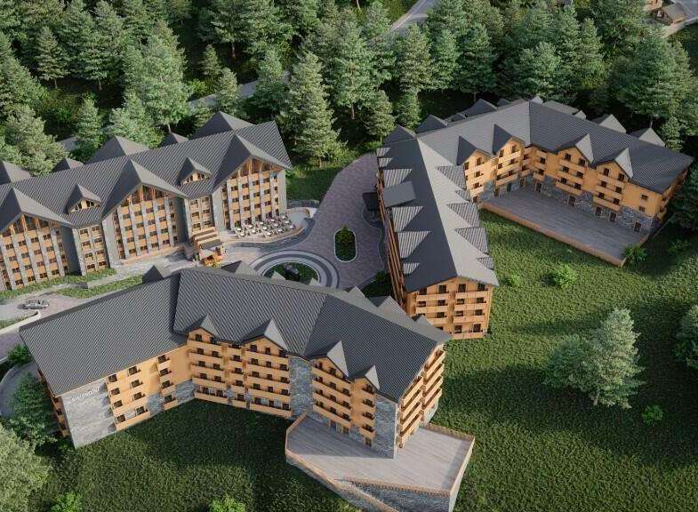 Nestled in a lush forest, this stunning hotel complex boasts multiple buildings with charming wooden accents and spacious balconies.