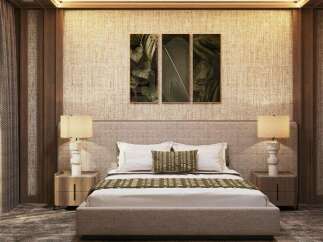 This luxurious bedroom boasts a sophisticated design with a beige woven headboard, complemented by stylish lamps and nightstands.