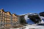 This stunning ski resort property boasts breathtaking mountain views and modern architectural design.
