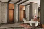 This luxurious lobby boasts two elegant copper elevators framed by textured gray stone walls and sleek dark accents.