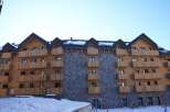 This stunning chalet-style hotel boasts a unique blend of wood and stone, creating a warm and inviting atmosphere.