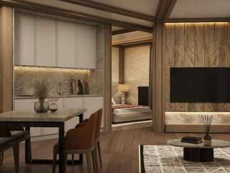 This stunning apartment boasts a modern kitchen with sleek cabinetry and granite countertops, seamlessly flowing into a cozy living area with a large flat-screen TV and stylish wooden wall accents.