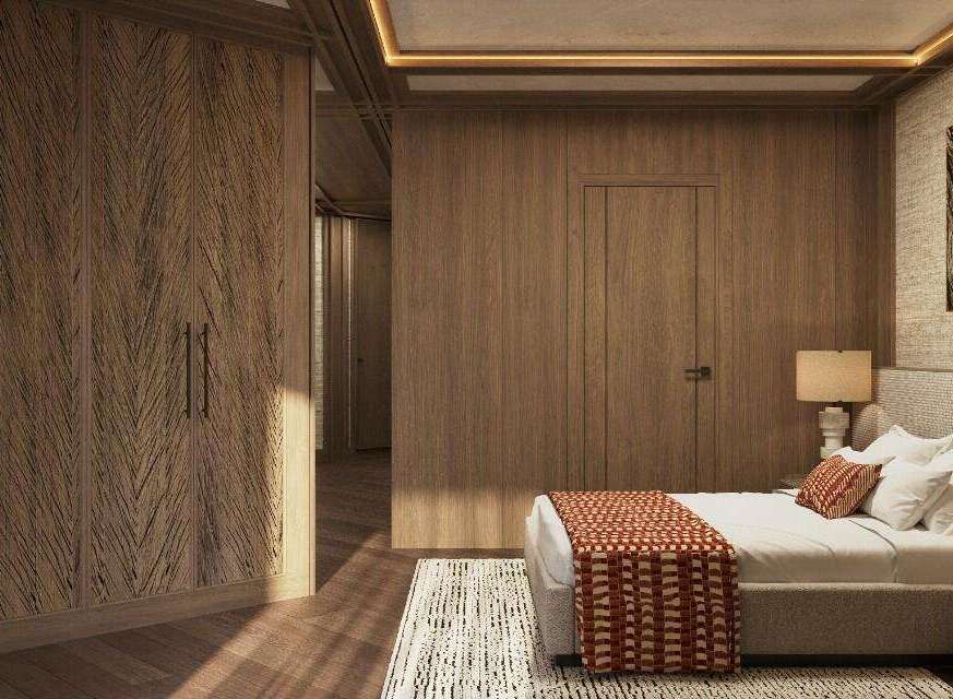 This luxurious bedroom boasts a stunning wood-paneled wall, complemented by a plush bed with a textured throw.