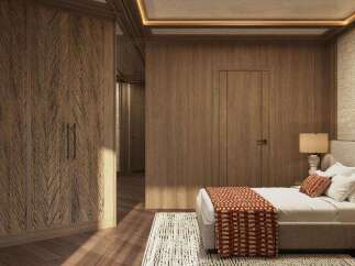 This luxurious bedroom boasts a stunning wood-paneled wall, complemented by a plush bed with a textured throw.