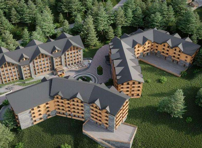 Nestled in a lush forest, this stunning hotel complex boasts multiple buildings with charming wooden accents and spacious balconies.