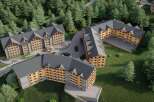 Nestled in a lush forest, this stunning hotel complex boasts multiple buildings with charming wooden accents and spacious balconies.