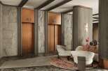 This luxurious lobby boasts two elegant copper elevators framed by textured gray stone walls and sleek dark accents.