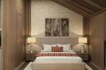 This stunning bedroom boasts a cozy and sophisticated atmosphere, featuring a plush bed with a textured headboard and warm-toned bedding.