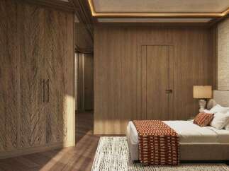 This luxurious bedroom boasts a stunning wood-paneled wall, complemented by a plush bed with a textured throw.