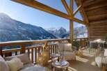 This stunning chalet boasts a spacious balcony with breathtaking mountain views, perfect for enjoying a morning coffee or evening apéritif.