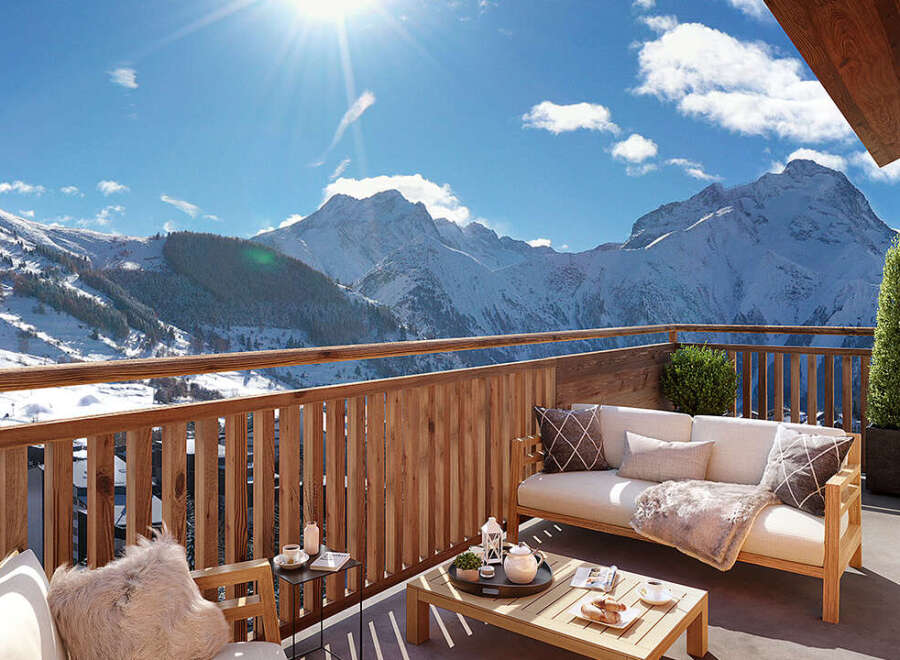 Luxury chalet apartment balcony with breathtaking mountain views.