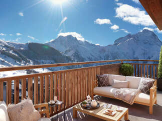 Luxury chalet apartment balcony with breathtaking mountain views.